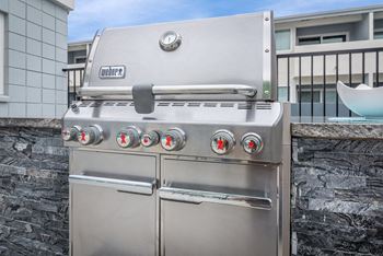 a stainless steel barbecue grill on a patio at Park Apartments, California, 90650